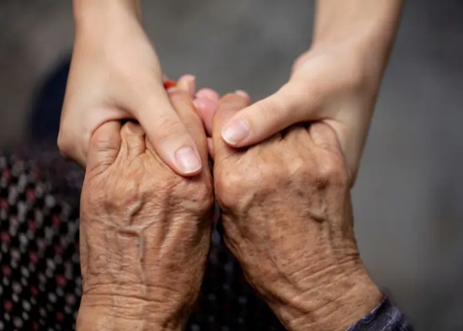 holding a service user's hand