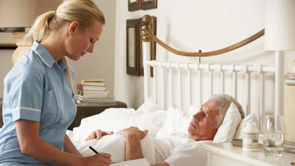 carer attending to service user in bed